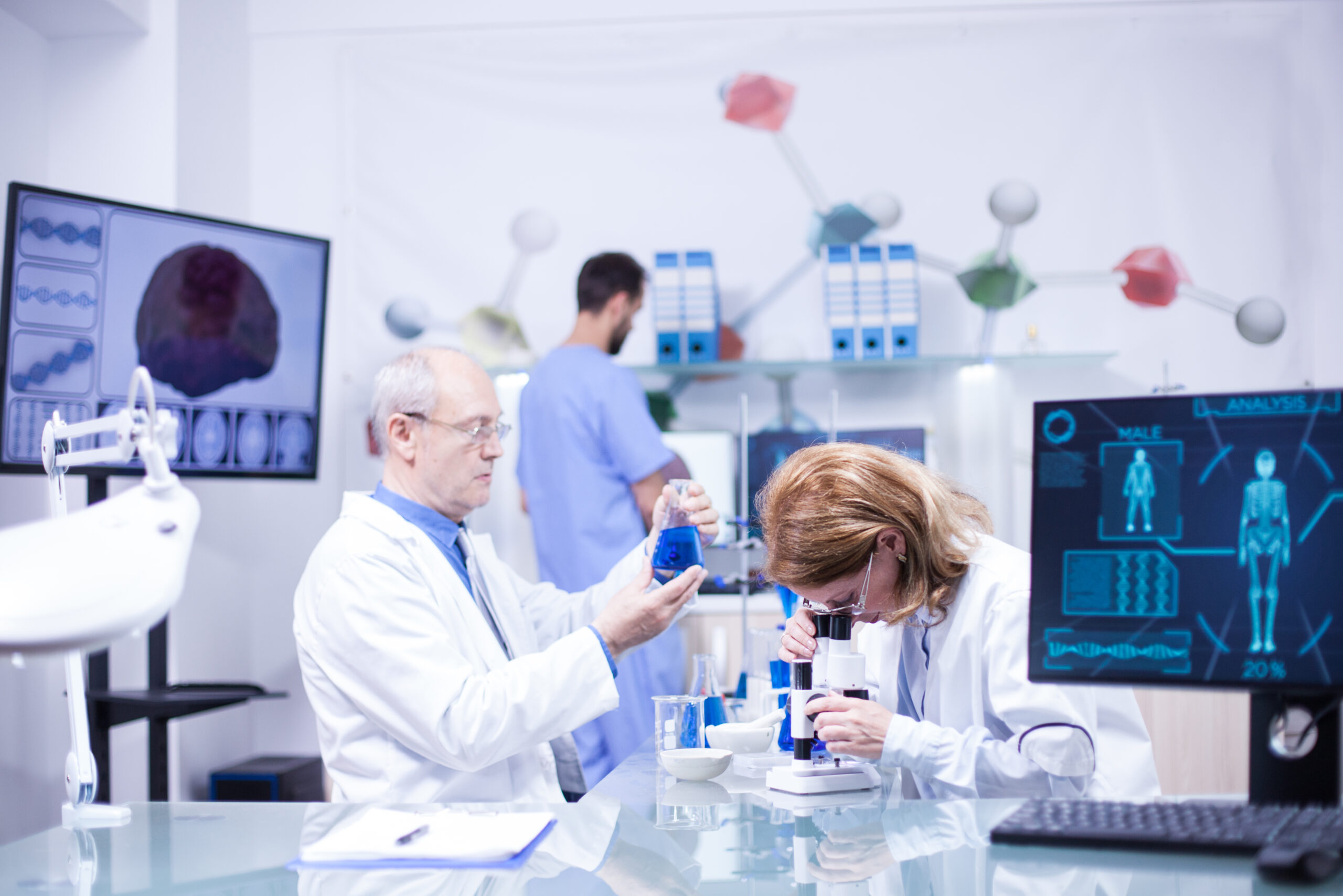 Groupe of researchers in pharmacology in a hospital laboratory. Modern equipment in research laboratory.